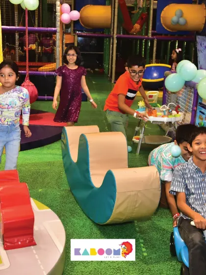 The play area is a dynamic space with kids riding, climbing, and exploring all at once.