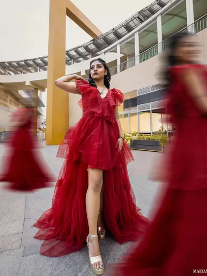 A high-fashion red tulle gown with a high-low hemline. This was a fun, dramatic piece to create for the concept photoshoot.