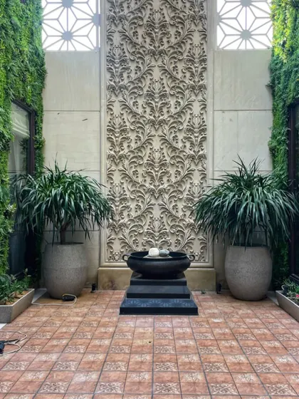This stunning courtyard in Gurgaon, with two large Dracaenas in polymer pots, was also featured as a location for the show. The symmetrical design creates a sense of grandeur.