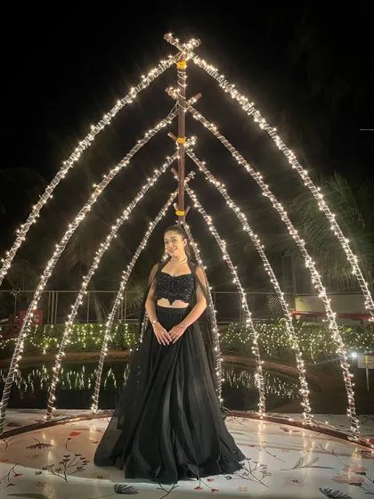 "Darling, never whine, just shine." Standing under a canopy of fairy lights, feeling ready to take on the stage for a Sangeet night.
