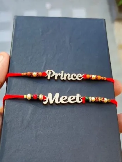 A pair of custom rakhis with names cut out in a stylish script font.
