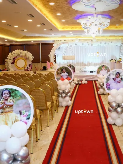 A wide shot of the venue with the white fairy theme, showing the guest seating and aisle decor.