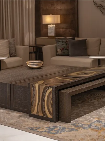 A close-up of the custom coffee table and sofa from our DLF Camellias project. The table's carved metal top is a testament to our in-house manufacturing capabilities and attention to detail.