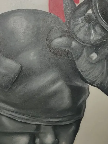 A close-up of one of the characters from the "STATES OF MIND" series. This character is blindfolded, with hands holding a magnifying glass, representing a state of scrutiny or inspection.