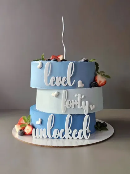 Level Forty Unlocked! A unique zigzag stacked cake for a 40th birthday. This lemon blueberry cake is a modern and stylish way to celebrate a milestone.