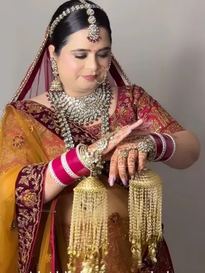A beautiful bride in a unique yellow and maroon lehenga. The makeup is kept soft and glowing to complement the heavy silver jewellery.