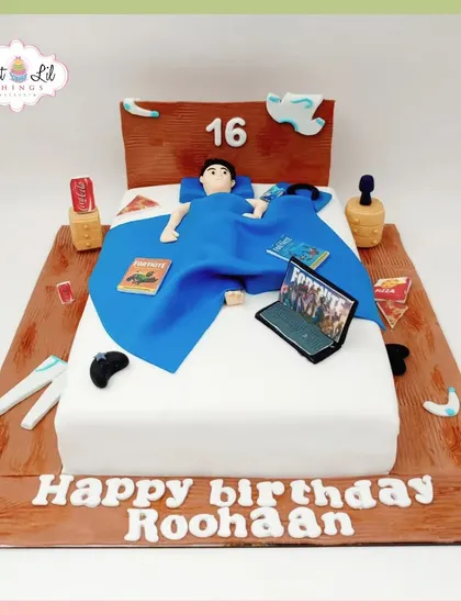 Level 16 unlocked! A cake depicting a teenager's ultimate chill zone: in bed with a laptop for Fortnite, a controller, and snacks.