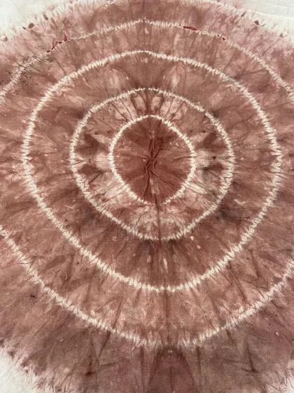 A circular tie-dye pattern, creating concentric rings of color. This is achieved by gathering the fabric in the center before tying.