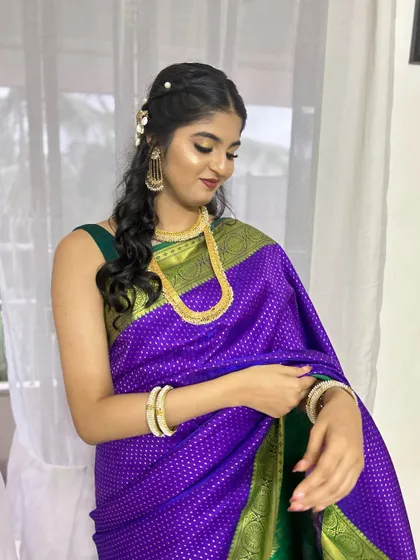 A beautiful bridesmaid in a purple Maharashtrian saree. The gold eyeshadow and red lip create a stunning contrast.