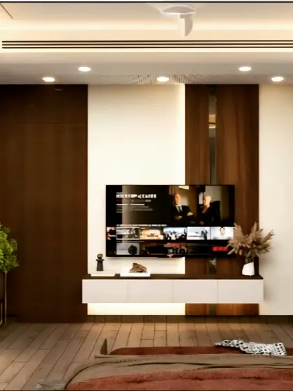 This bedroom TV unit combines dark wood paneling with a white floating console. The design is simple yet elegant, with recessed ceiling lights providing ample illumination for the space.