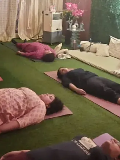 Students in a state of deep relaxation during Yog Nidra, or yogic sleep. This guided meditation technique induces complete physical, mental, and emotional relaxation.