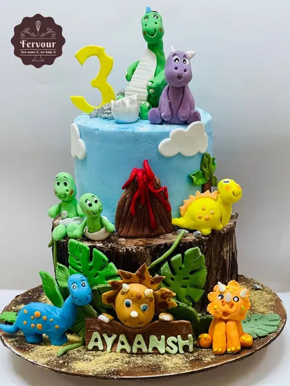 A roaring success, this dinosaur-themed cake is filled with hand-crafted, friendly dinosaurs and a volcano. The different textures of the log base and the blue sky make it a visually exciting centerpiece for a 3rd birthday.
