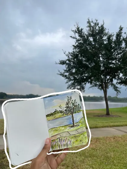 A beautiful watercolor painting in my sketchbook, with an outline to make it pop against the real-life background.