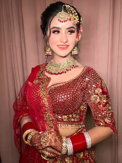 A smiling shot that shows off the complete look, including the beautiful floral bun.
