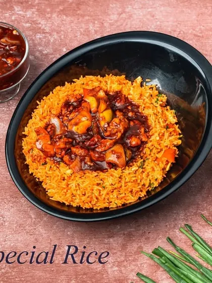 The Safeer Special Rice is a signature creation. It's a flavorful rice dish topped with a special savory sauce and tender pieces of chicken, offering a unique taste you'll only find here.