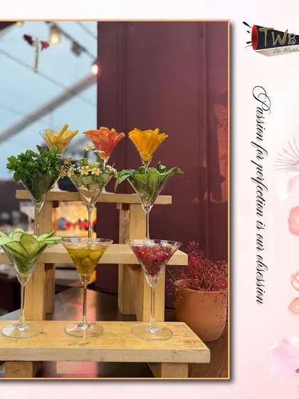 An artistic display of fresh garnishes, from herbs and flowers to sliced fruits, ready to be used in our handcrafted cocktails. We believe the garnish is the final touch of artistry.