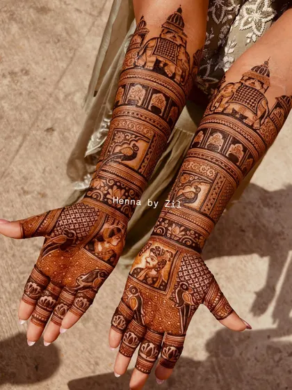 A truly royal design featuring story bands of peacocks and elephants. The intricate details and symmetrical patterns create a stunning effect that extends up the arms.