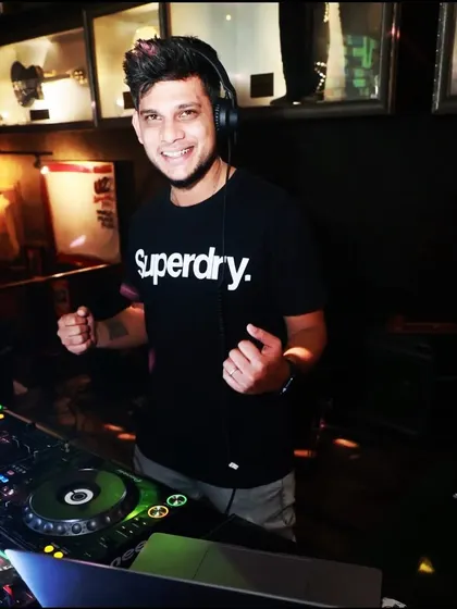 A happy, confident shot from behind the decks at Hard Rock Cafe. I'm comfortable and experienced in any venue.