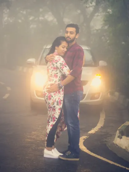 Using car headlights to cut through the fog at Nandi Hills for a pre-wedding shoot. This technique creates a moody, film-like scene that feels both intimate and dramatic.