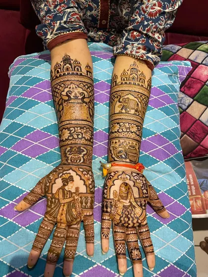 A classic Rajasthani bridal set with matching designs on both arms. The palms feature dulha-dulhan figures, while the arms are decorated with elephants and palace architecture.