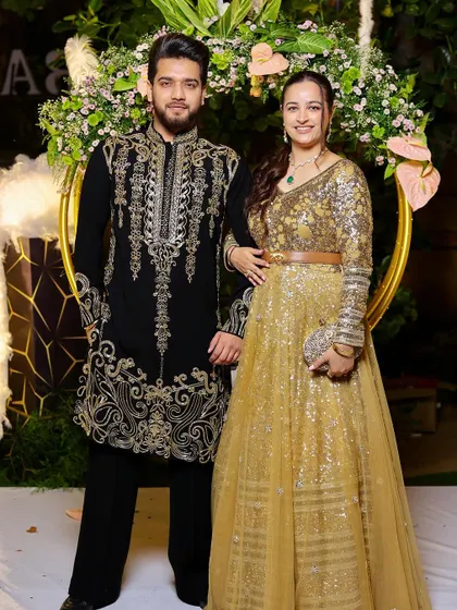 Together for the festival of lights. The rich embroidery on the black kurta stands out, making it an ideal choice for a celebratory evening.