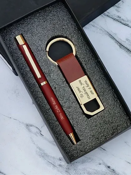 A closer look at the maroon pen and keychain set for teachers, engraved with "To your students, you are a hero."