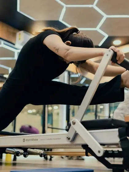 A deep hamstring stretch on the Reformer that also requires core control to stabilize the pelvis. Flexibility and strength go hand in hand in my classes.
