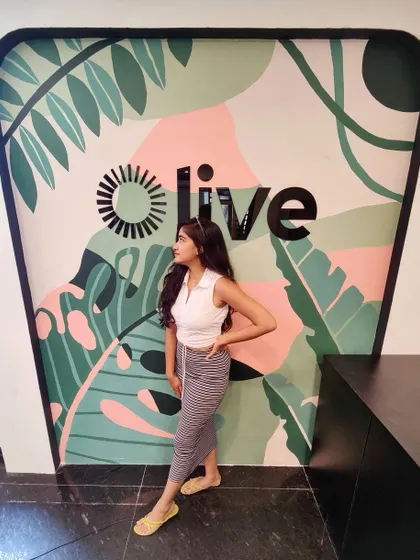 This mural for the 'Olive' reception area uses a modern, abstract take on tropical leaves with a soft color palette to create a welcoming entrance.