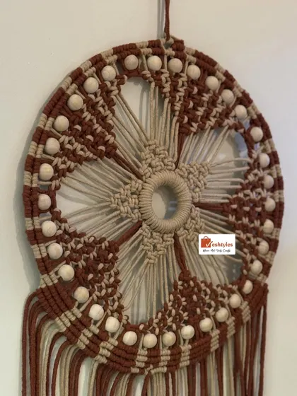The detail in this macrame dreamcatcher is what makes it a piece of art. The combination of brown and beige is timeless and elegant.
