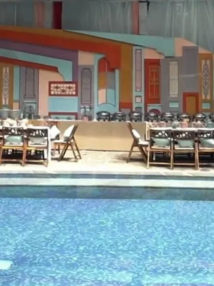 A closer view of the poolside food station, where the backdrop of colorful, layered panels created a festive and unique atmosphere.