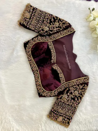 The back of the velvet blouse, showing the intricate embroidery and a stylish cutout.