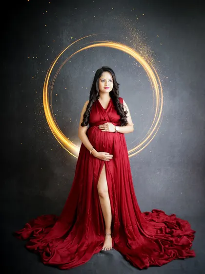A magical and artistic portrait. The mom-to-be is framed by a glowing ring of light, creating a stunning and otherworldly effect.