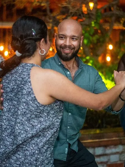A close and connected dance with a beautiful smile.