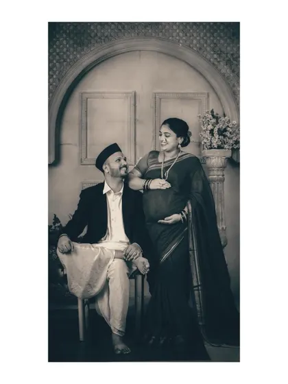 The emotional connection between the couple is amplified in this black and white composition. Their expressions and body language tell a story of shared love and anticipation without the distraction of color.