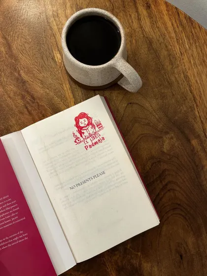A quiet moment with a book and a black coffee. This book, 'No Presents Please', is by a regular at our reading socials.