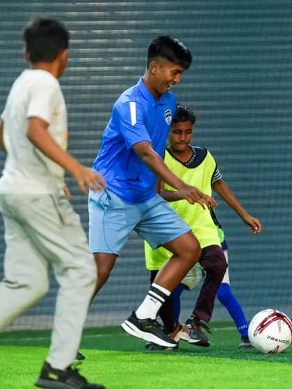 Shivaldo Singh dribbles past a young opponent during the fun and games at our Grassroots Festival.