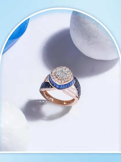 This ring is an example of wearable art from my women's collection. It features a cluster of natural diamonds surrounded by blue sapphires, set in a beautifully designed rose gold band.