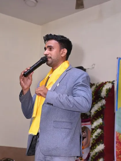 Addressing the audience at the cultural event, grateful for the opportunity to share my magic.
