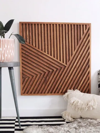 A single square panel of our bohemian wooden wall art. The design is complex yet balanced, making it a beautiful addition next to a plant and modern furniture.