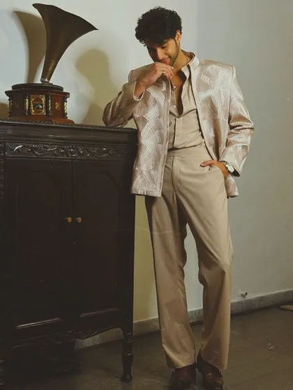 Siddhant Chaturvedi in a sophisticated beige three-piece ethnic set by Faraz Manan. The subtle geometric pattern on the jacket adds a layer of modern elegance.