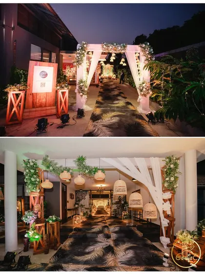 The entrance to a rustic-themed event, featuring a custom-printed carpet, wooden elements, and soft lighting.