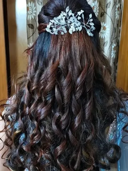 The back view of the romantic half-up style, showing the beautiful flow of the curls.