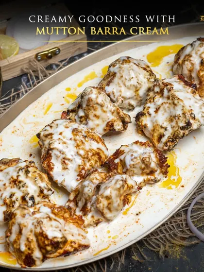 Here is another look at the creamy goodness of Mutton Barra Cream. You can see the tender, char-grilled mutton peeking through the rich white sauce, garnished with a drizzle of butter. It's a melt-in-your-mouth experience you won't forget.