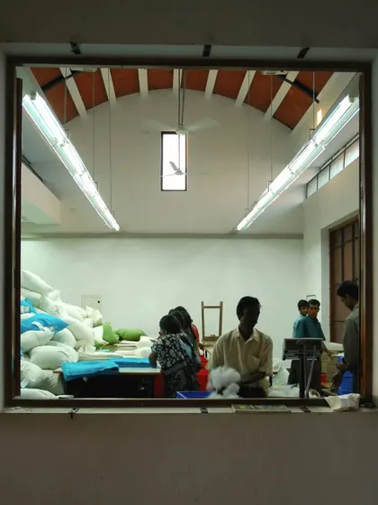 A view from the outside looking into a work area at the Synergy factory. The design provides workers with a connection to the outdoors and ample natural light, creating a healthier and more pleasant environment than a typical factory floor.