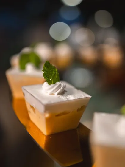 A close-up of our light and airy mousse cups, garnished with fresh mint.