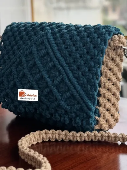 A two-tone sling bag in teal and beige. The contrast is so striking and stylish.