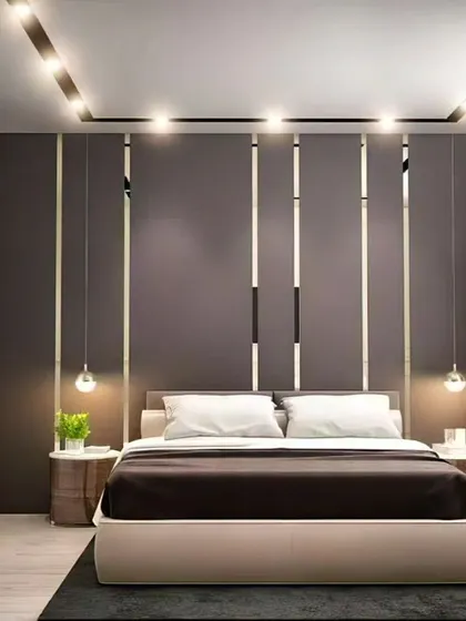 This bedroom design uses vertical metallic and mirrored strips on the accent wall to create a sense of height and glamour. The simple platform bed and hanging pendant lights complete the chic, contemporary look.