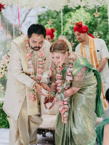 The couple performing rituals together at their Muhurtham. We ensure that the significance of each step is explained, making the ceremony meaningful for both partners.