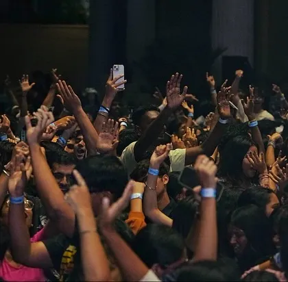 A shot of the massive student crowd with their hands in the air during my set. This is the result I aim for: a fully engaged and energized audience.