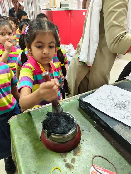 A student gets a close look at the official post office seal, a fascinating detail from their hands-on learning experience.
